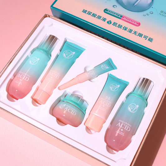 Set of skincare products with gradient design in a box on a pink background