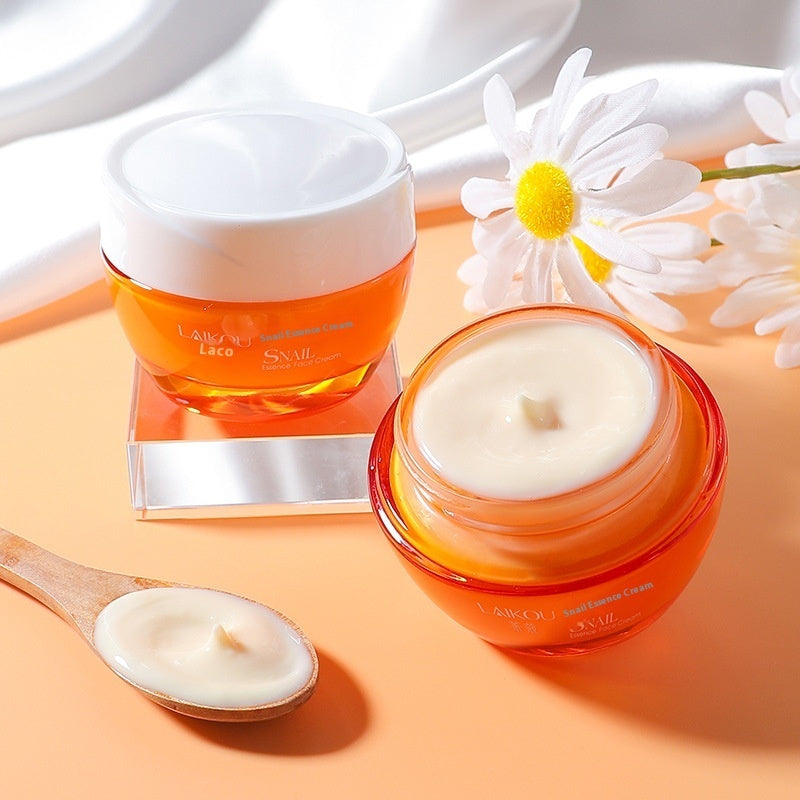Two jars of cream with a spoonful of cream and daisies on a peach background