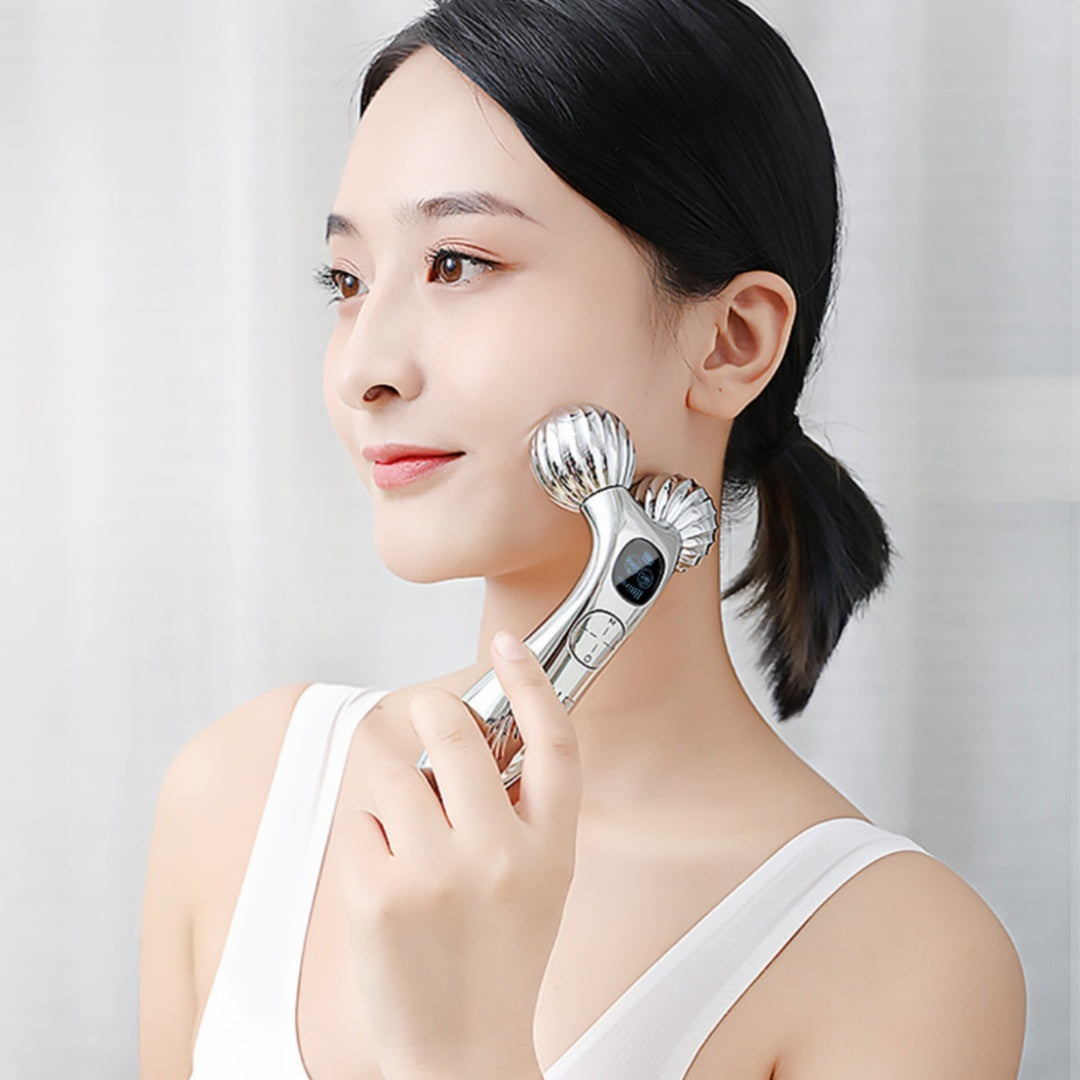 Woman using a facial massager on her face against a plain background