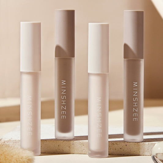 Four lip gloss tubes with 'MINSHZEE' branding on a neutral background