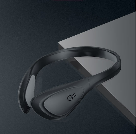 Black massage neckband on a dark gray background