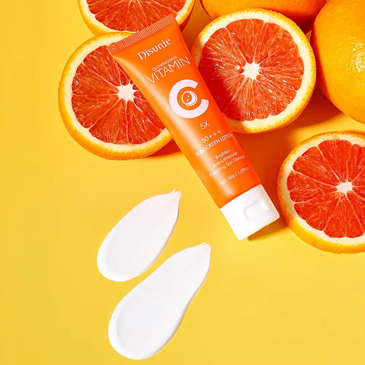 Tube of Divine Vitamin C skincare product surrounded by sliced oranges on a yellow background